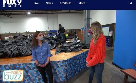 Shayne Wells of Fox9 discusses inflatables with Stephanie Meacham during her tour at Landmark Creations